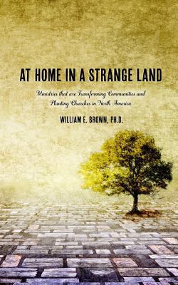 At Home in a Strange Land 1935986945 Book Cover