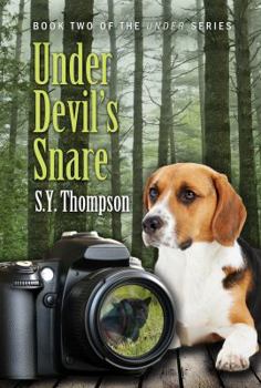 Paperback Under Devil's Snare Book