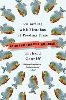 Paperback Swimming with Piranhas at Feeding Time: My Life Doing DUMB STUFF with Animals Book