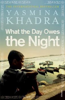Paperback What the Day Owes the Night Book