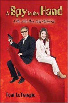 Paperback A Spy In The Hand: A Mr. And Mrs. Spy Mystery Book
