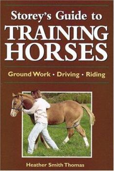 Paperback Storey's Guide to Training Horses Book