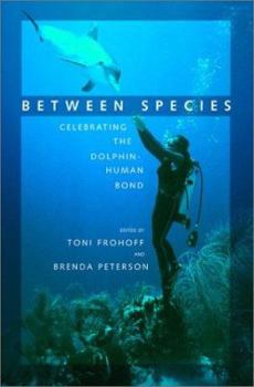 Hardcover Between Species: Celebrating the Dolphin-Human Bond Book