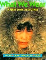 What We Wear: A First Look at Clothes (Play and Discover Series.) 1568471432 Book Cover