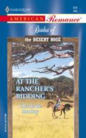 At the Rancher's Bidding 0373169299 Book Cover