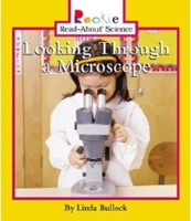 Looking Through a Microscope 0516279122 Book Cover